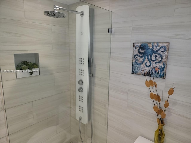 bathroom featuring a shower with door