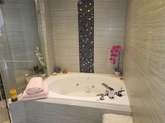 bathroom featuring a relaxing tiled tub