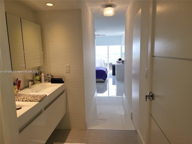 bathroom featuring ceiling fan, tile patterned flooring, and vanity