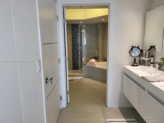 bathroom featuring plus walk in shower, tile patterned floors, and vanity