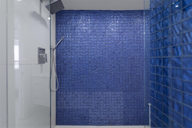 bathroom with tiled shower