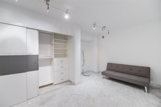 bedroom featuring a closet and rail lighting