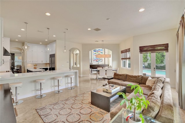 living room featuring french doors and sink