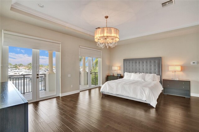 dining area featuring crown molding, a tray ceiling, and decorative columns