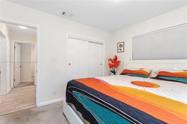 bedroom featuring a closet and light carpet