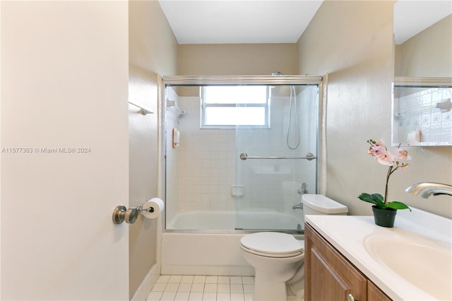 full bathroom featuring bath / shower combo with glass door, toilet, tile floors, and vanity