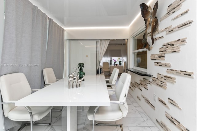 dining area featuring light tile floors