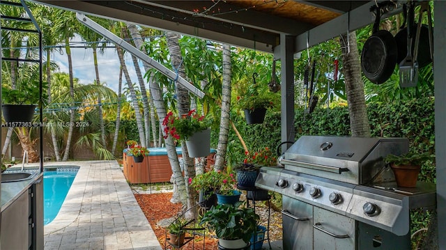 view of patio / terrace with a fenced in pool and a grill