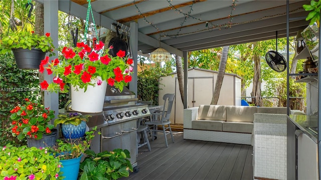 wooden terrace with outdoor lounge area and a storage shed