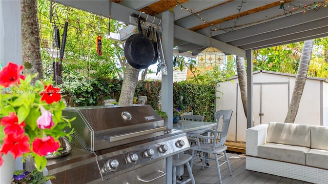 view of patio featuring a wooden deck and a grill