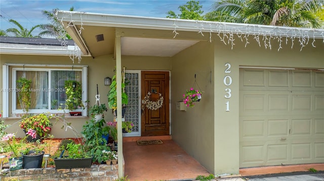 view of exterior entry with a garage