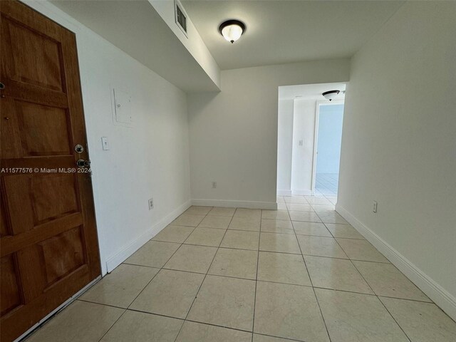 spare room with light tile flooring