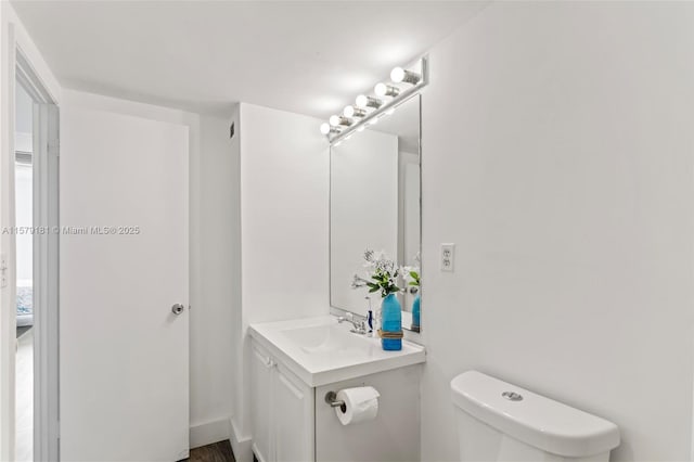 bathroom featuring toilet and vanity