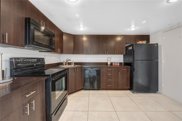 kitchen featuring light tile flooring, black appliances, sink, and dark brown cabinetry