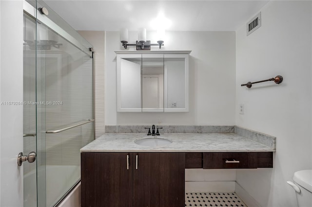 bathroom with toilet, tile floors, and vanity