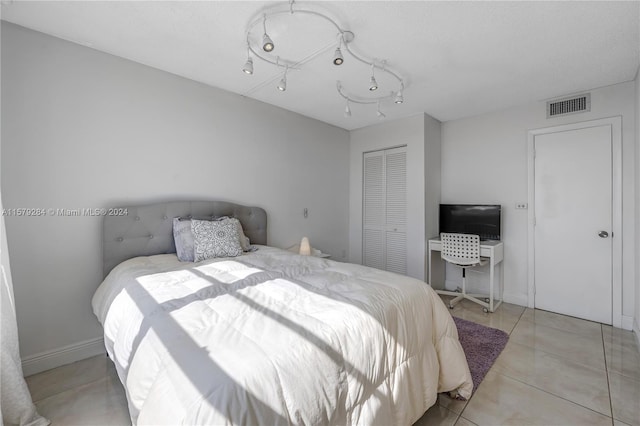 tiled bedroom featuring a closet