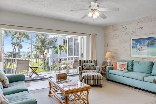 living room featuring a healthy amount of sunlight, a textured ceiling, and ceiling fan