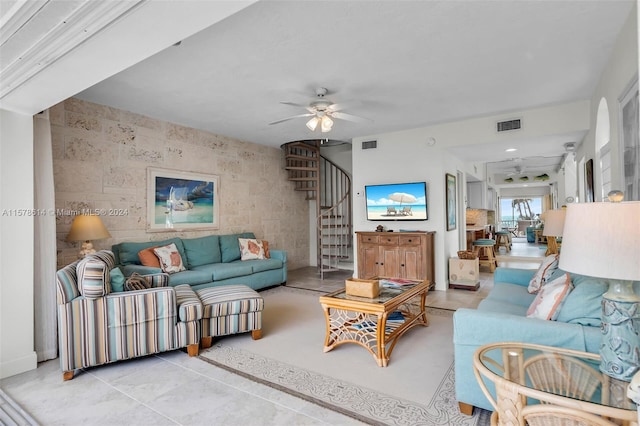 tiled living room with ceiling fan