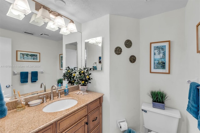 bathroom featuring oversized vanity and toilet