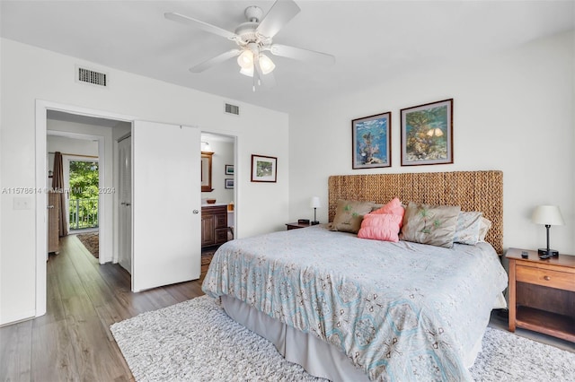 bedroom featuring connected bathroom, ceiling fan, and hardwood / wood-style flooring