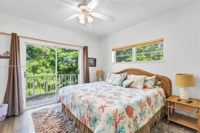 bedroom with wood-type flooring, access to exterior, and multiple windows