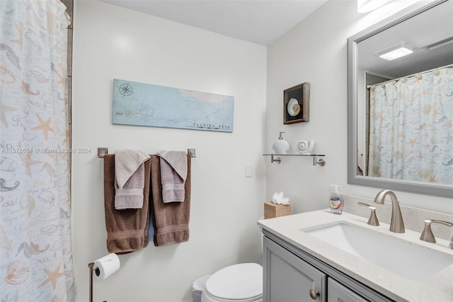 bathroom featuring oversized vanity and toilet