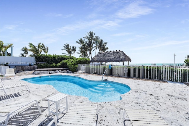 view of swimming pool featuring a hot tub and a patio area