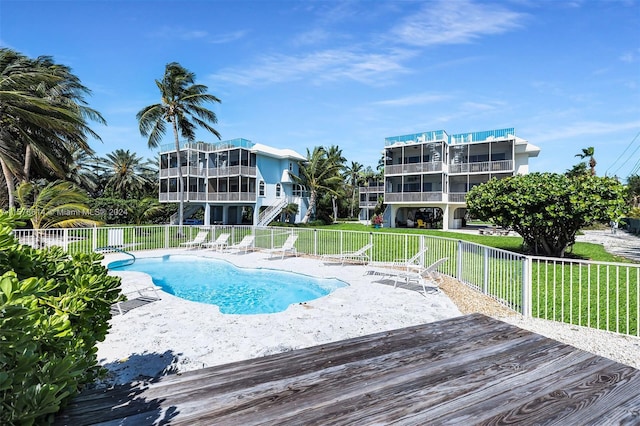 view of pool with a lawn