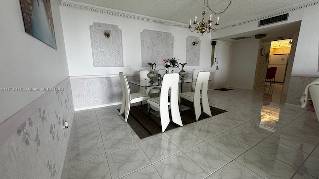 tiled dining space with a chandelier, a textured ceiling, and crown molding