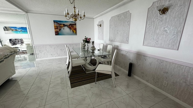 dining area with a notable chandelier, ornamental molding, a textured ceiling, and light tile flooring