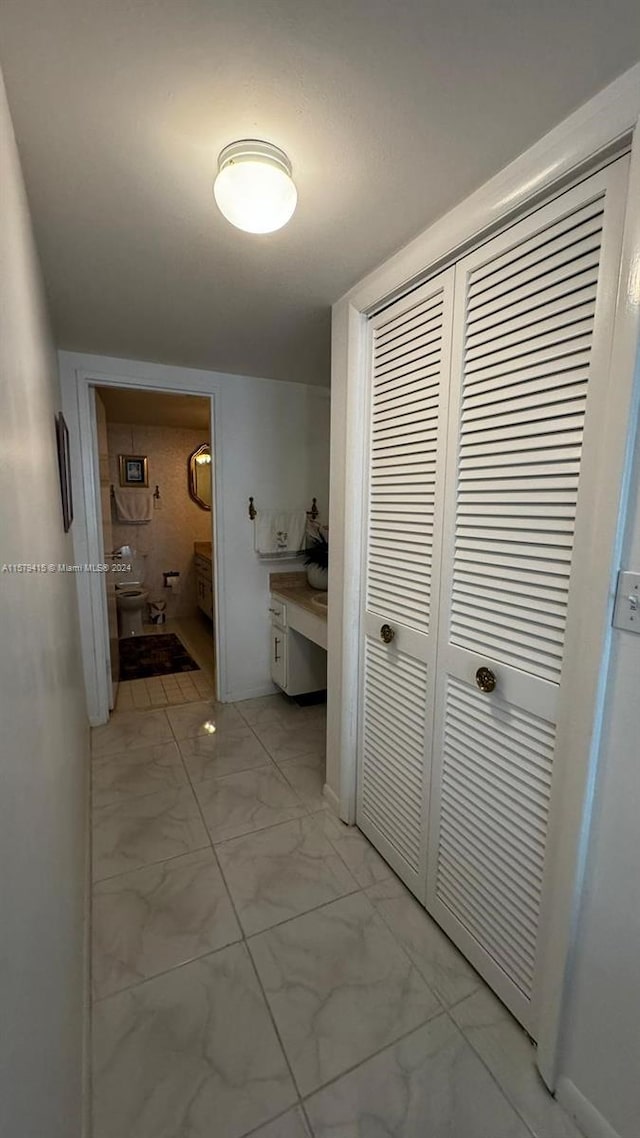 hallway featuring light tile flooring