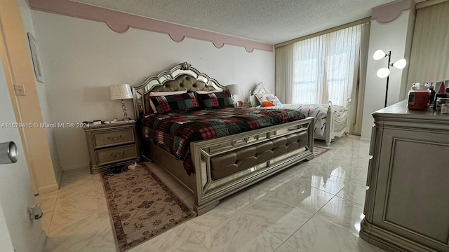 bedroom with a textured ceiling and light tile flooring