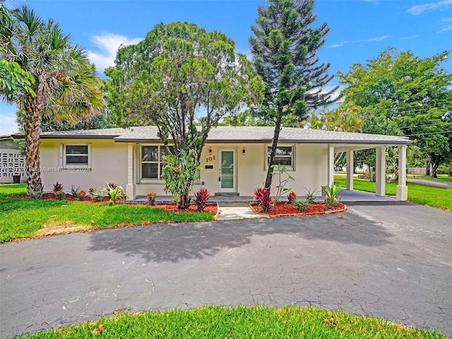 single story home featuring a carport