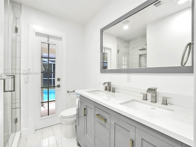 bathroom with an enclosed shower, toilet, tile flooring, and double sink vanity