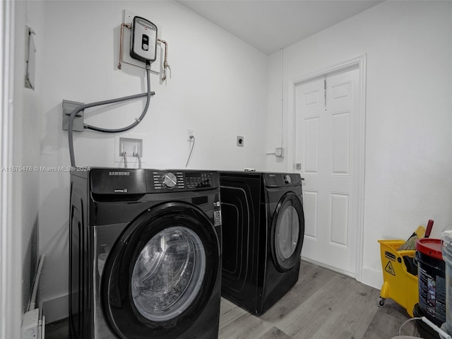 washroom featuring light hardwood / wood-style flooring, independent washer and dryer, electric dryer hookup, and hookup for a washing machine