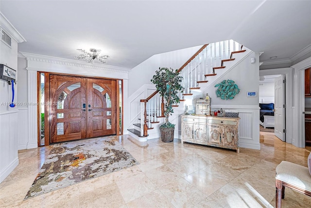 tiled entrance foyer with ornamental molding