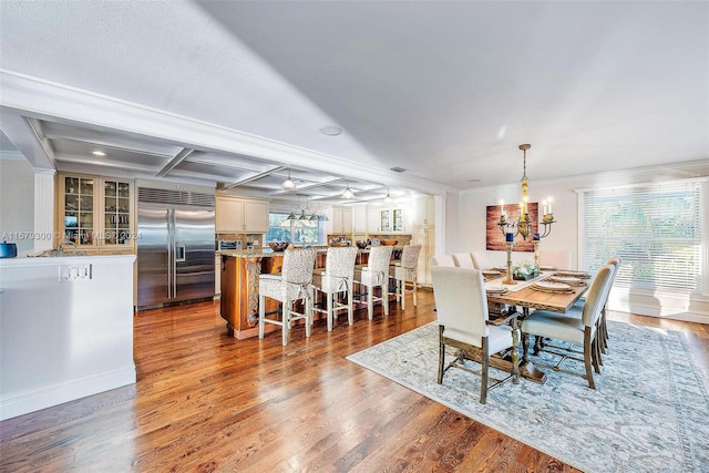 dining area with plenty of natural light and hardwood / wood-style flooring