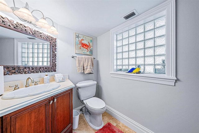 bathroom with tile flooring, vanity, and toilet