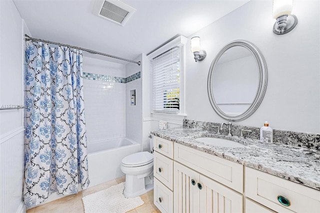 full bathroom with tile floors, vanity, toilet, and shower / bath combo with shower curtain