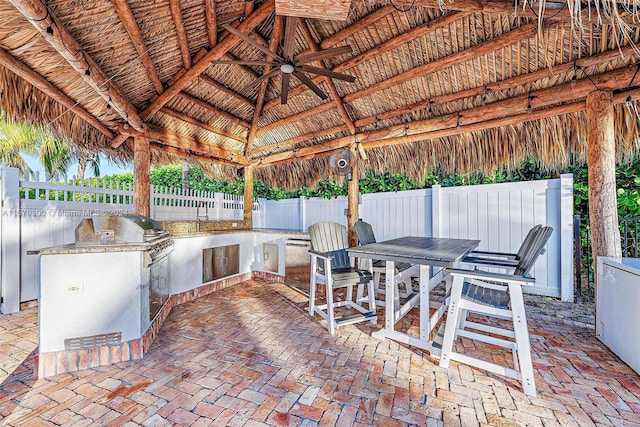 view of terrace featuring ceiling fan, a gazebo, area for grilling, and grilling area