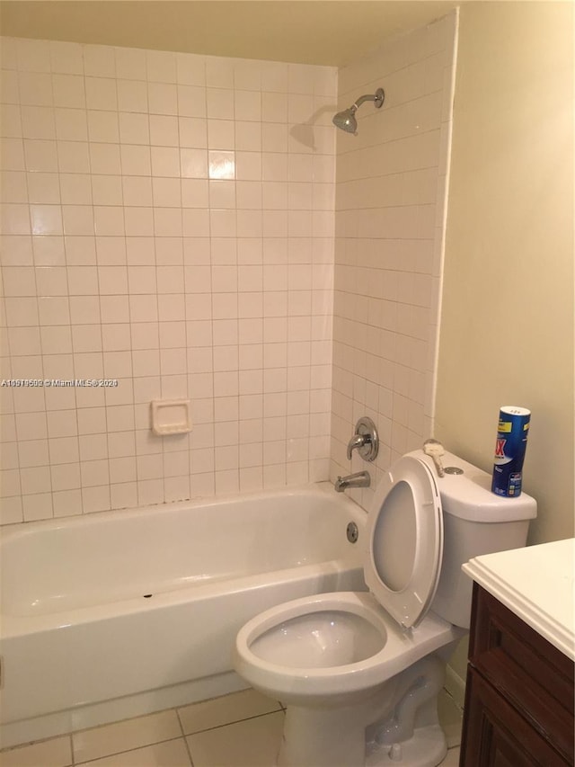 full bathroom featuring tiled shower / bath combo, toilet, tile flooring, and vanity