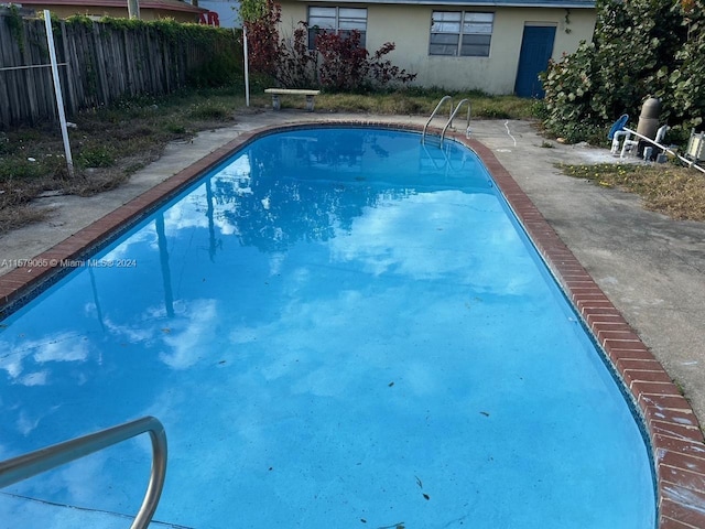 view of swimming pool featuring a fenced in pool and fence