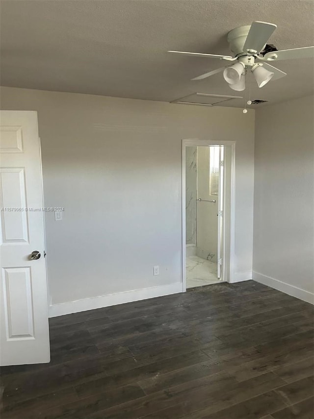 empty room featuring visible vents, a ceiling fan, a textured ceiling, wood finished floors, and baseboards