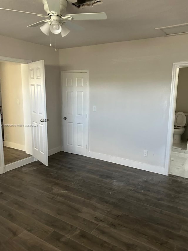 unfurnished bedroom featuring dark wood-style floors, baseboards, and a ceiling fan