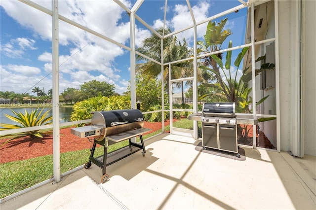 sunroom featuring a water view