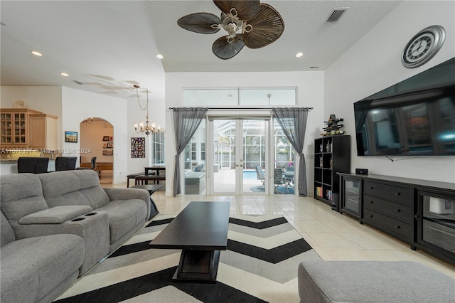 living area with arched walkways, french doors, light tile patterned floors, recessed lighting, and visible vents