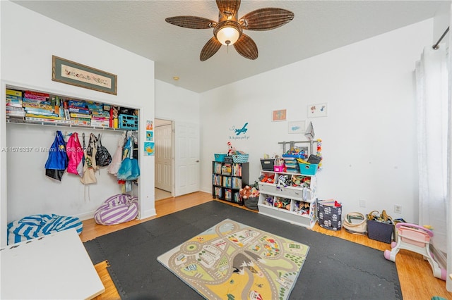 game room with ceiling fan and wood finished floors