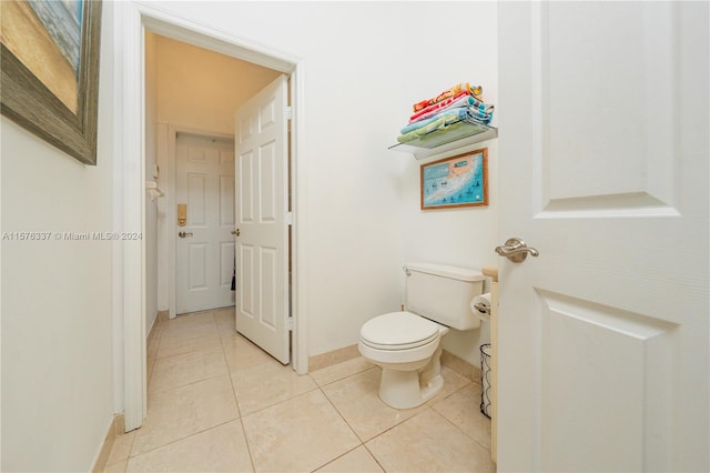 bathroom featuring toilet and tile patterned flooring