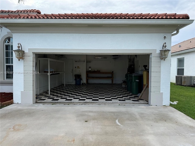 garage featuring electric panel and concrete driveway