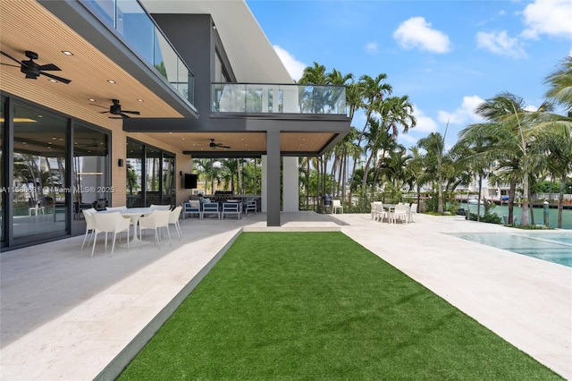 exterior space featuring a water view, ceiling fan, and a patio area